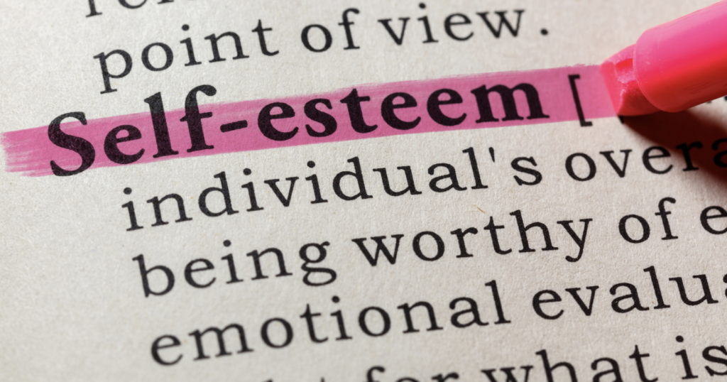 The word self-esteem is being highlighted by a pink highlighter